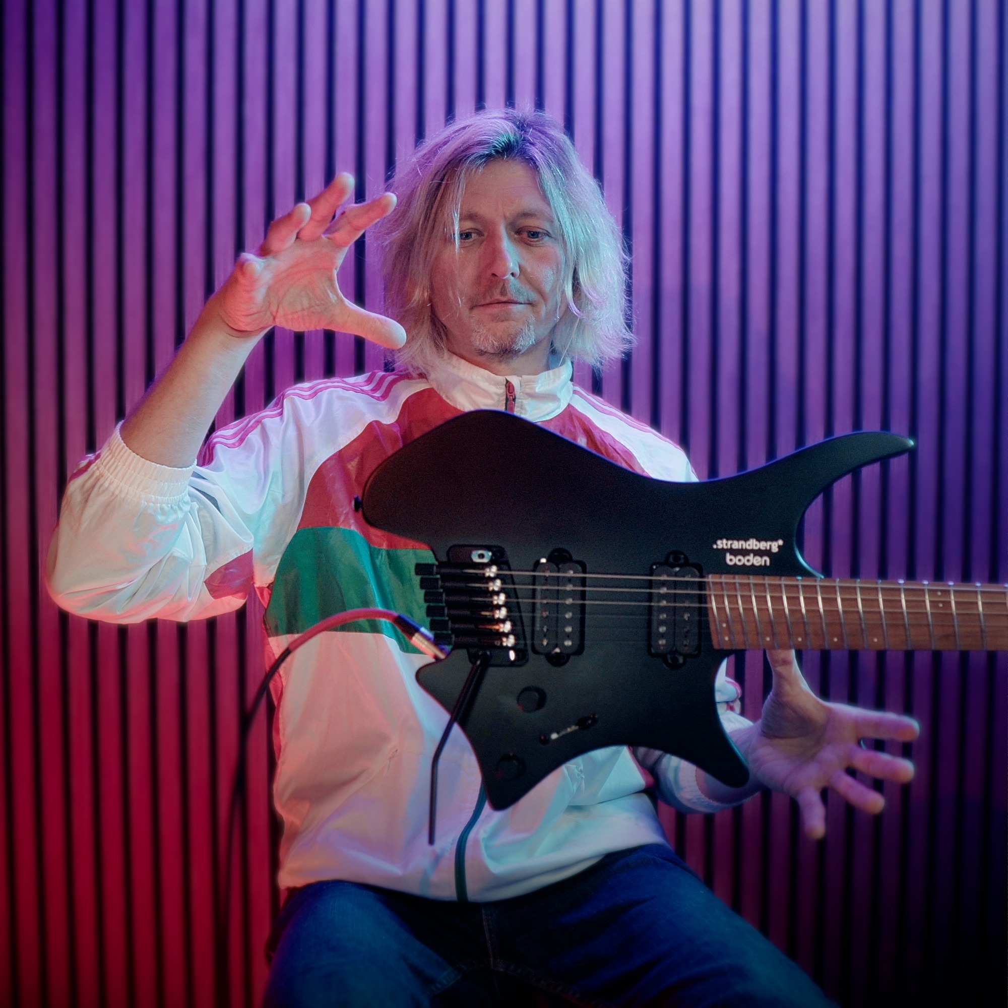 Tim Hutch with a Strandberg guitar in his studio